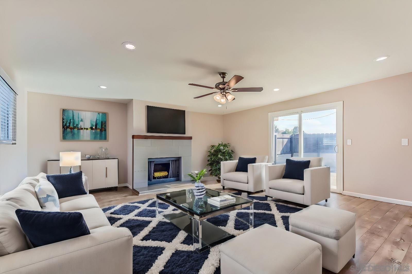 a living room with furniture a fireplace and a flat screen tv