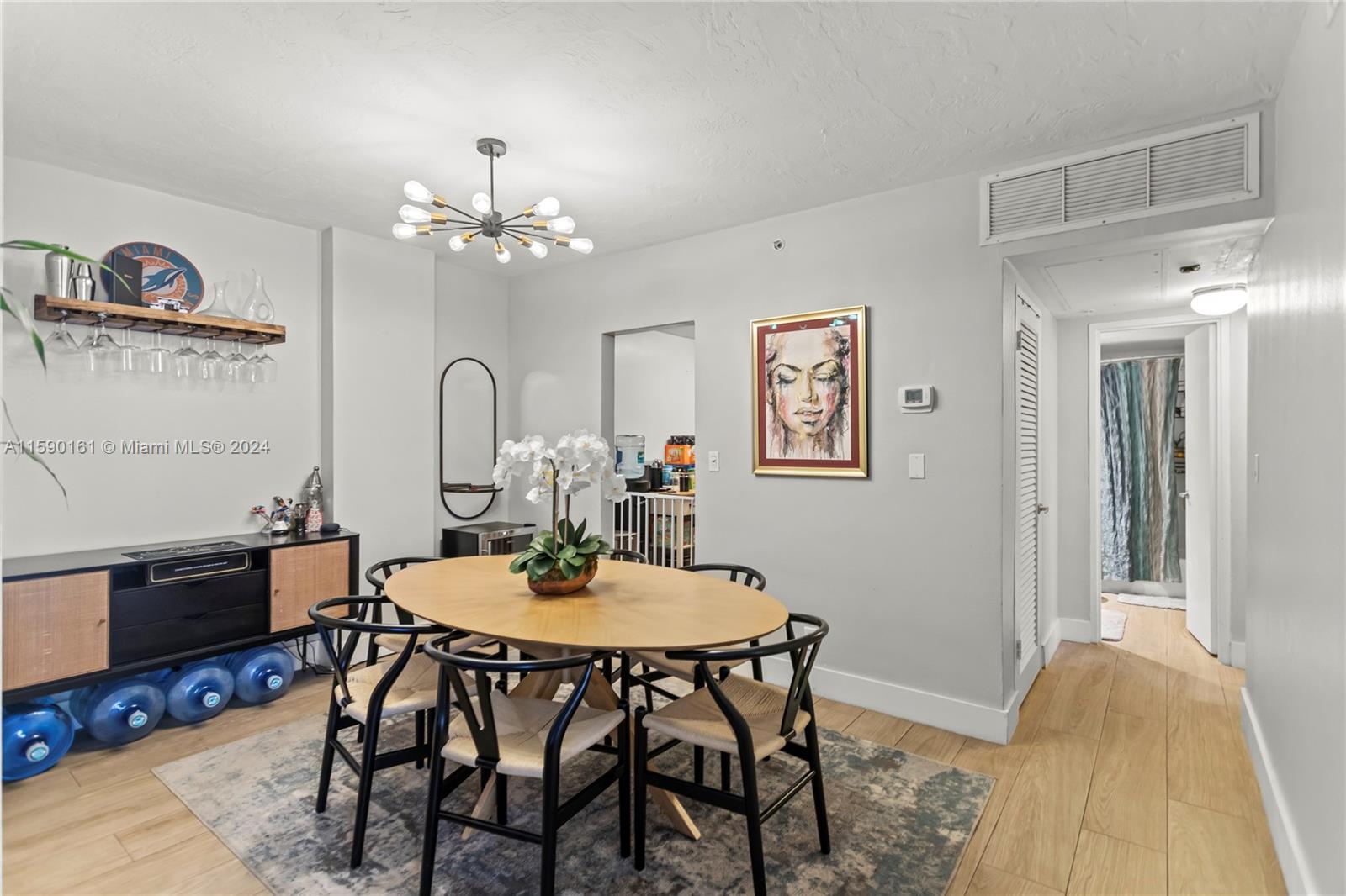 a dining room with furniture and chandelier