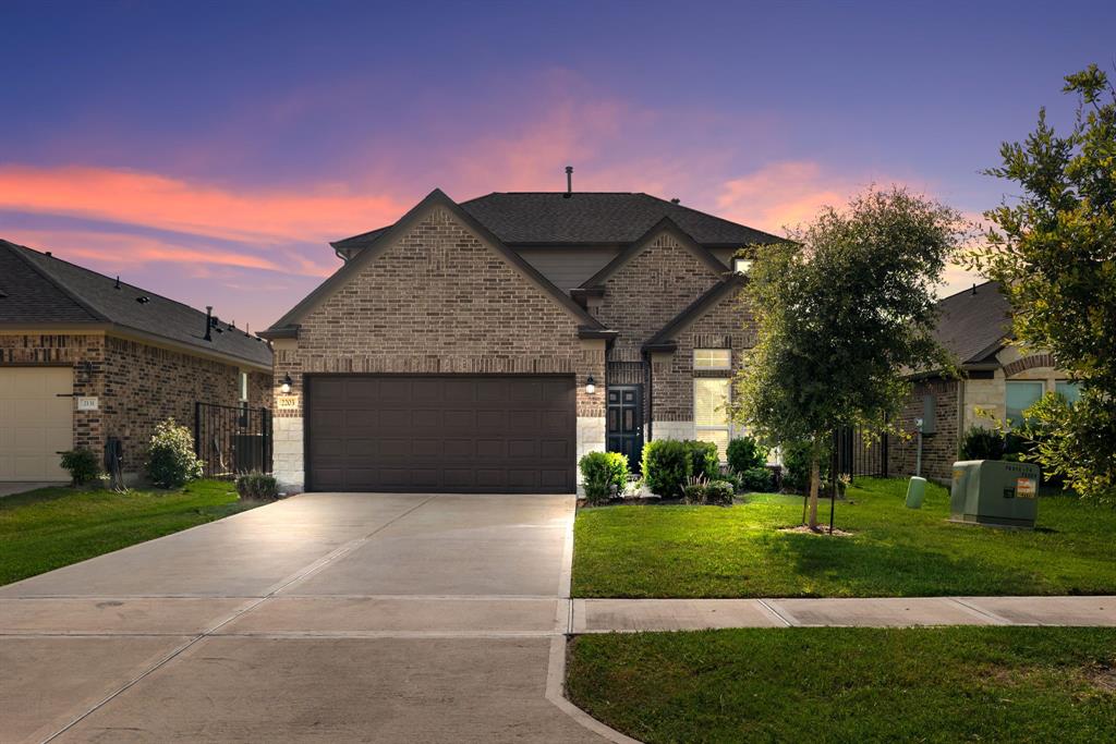 a front view of a house with a yard and garage