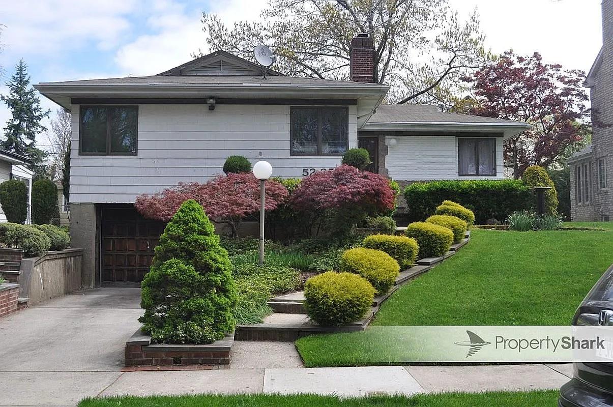 View of front of house with a garage and a front yard