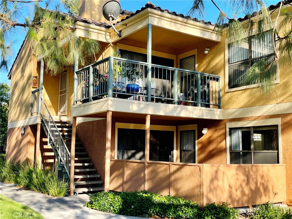 a view of a house with a yard and potted plants