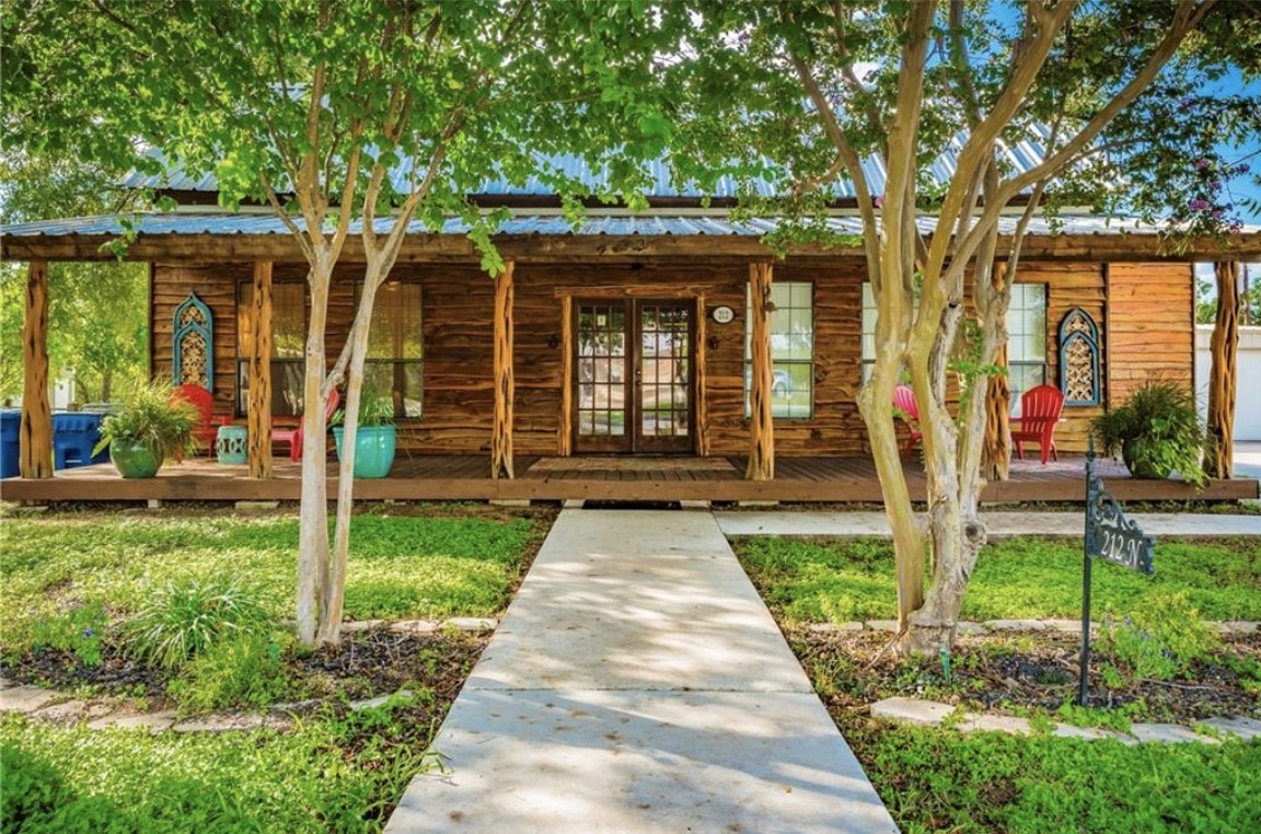 a front view of a house with garden