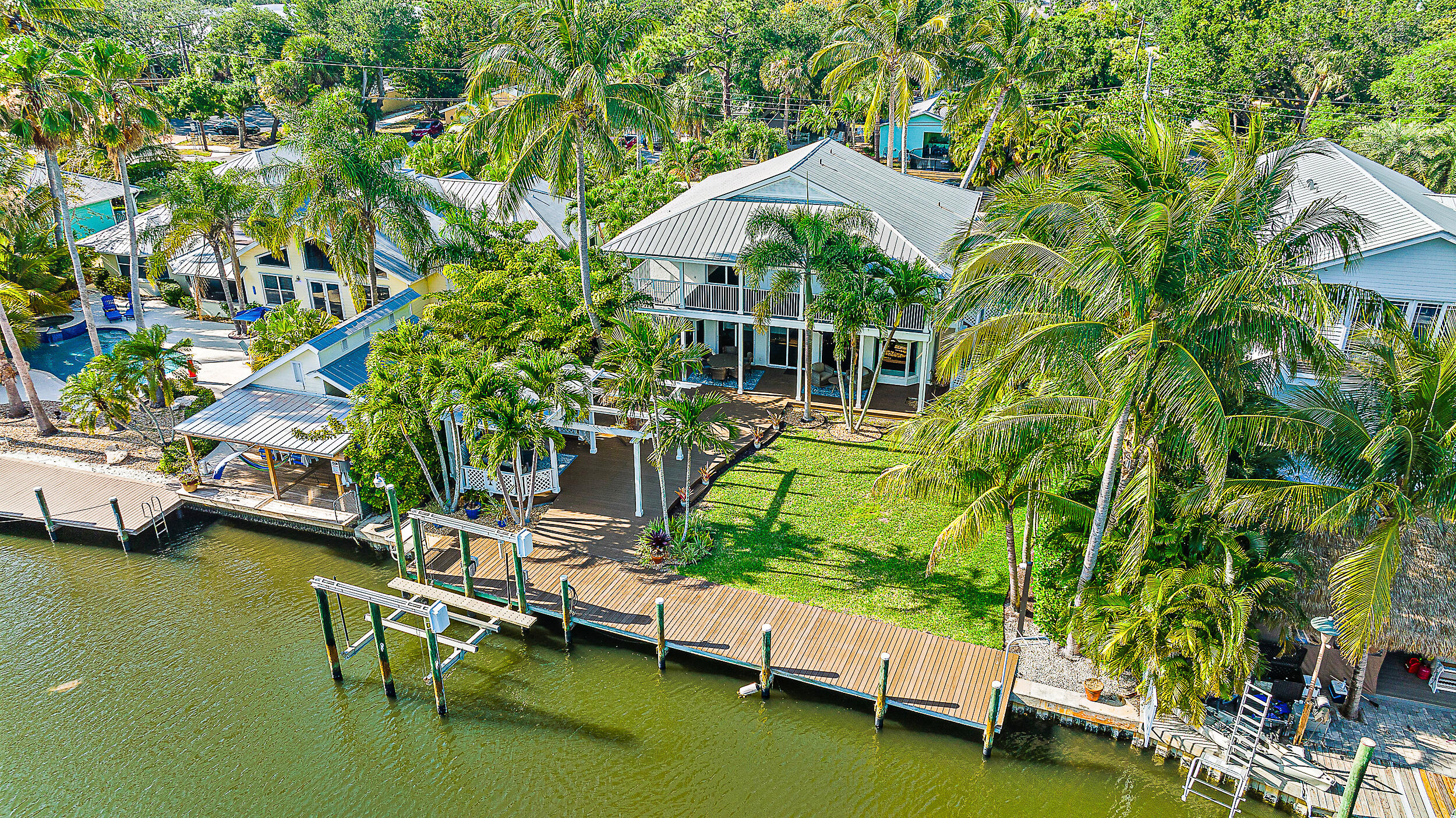 a view of a house with pool plants and a small yard