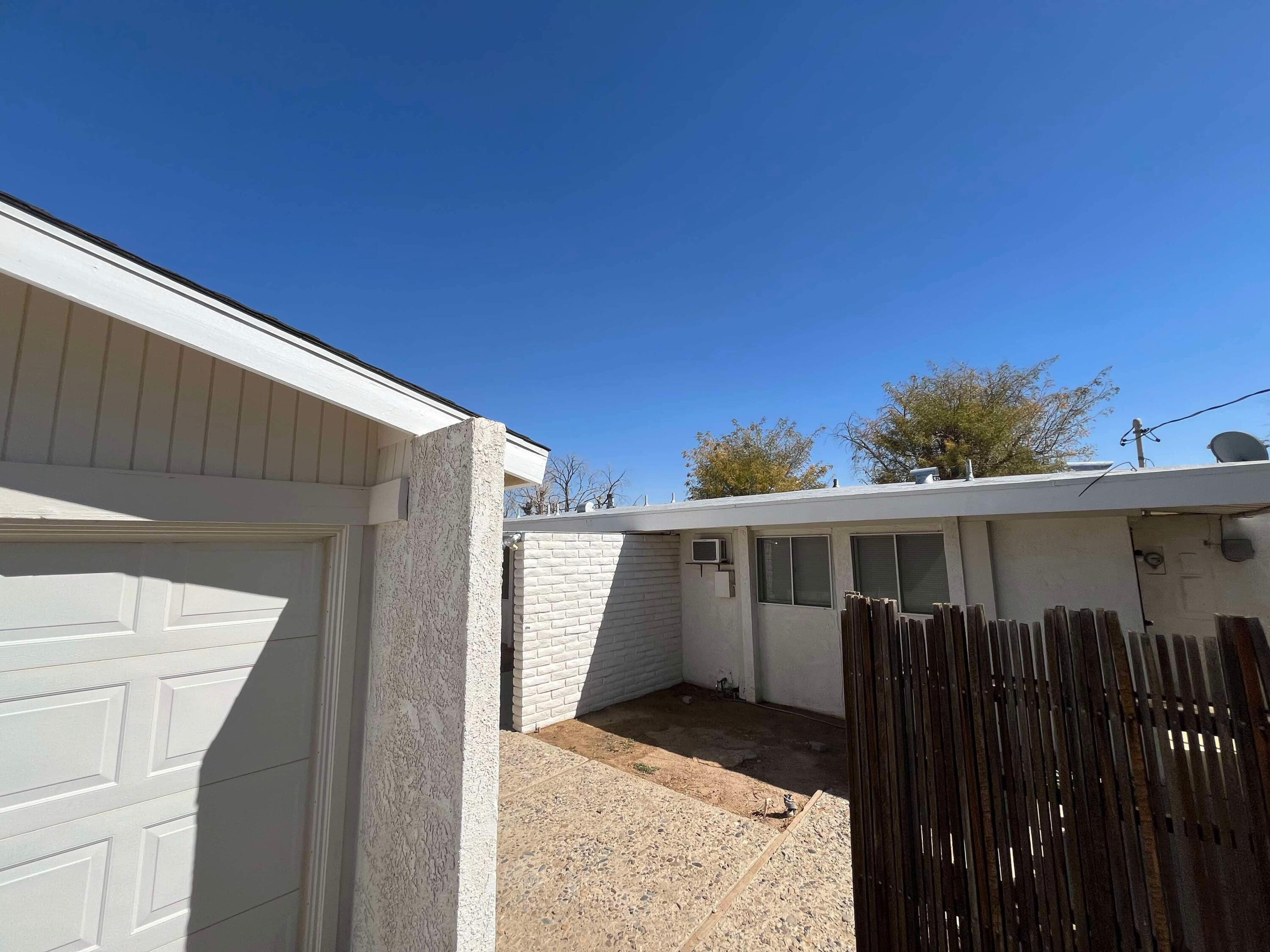 a view of a house with wooden fence