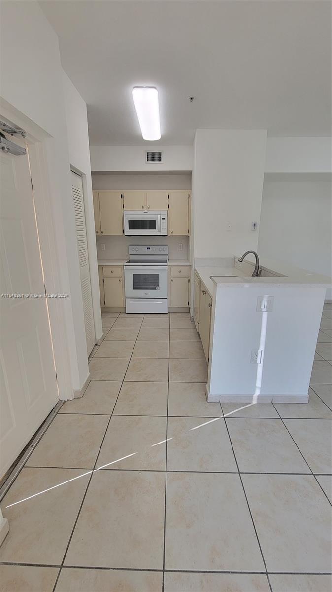 a kitchen with stainless steel appliances a sink and cabinets