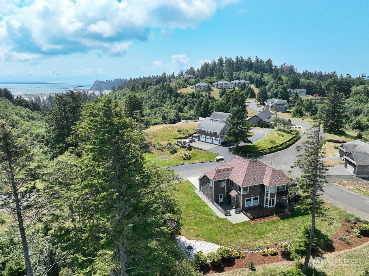 an aerial view of a house with a garden and lake view