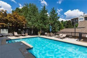 a view of a house with backyard sitting area and swimming pool