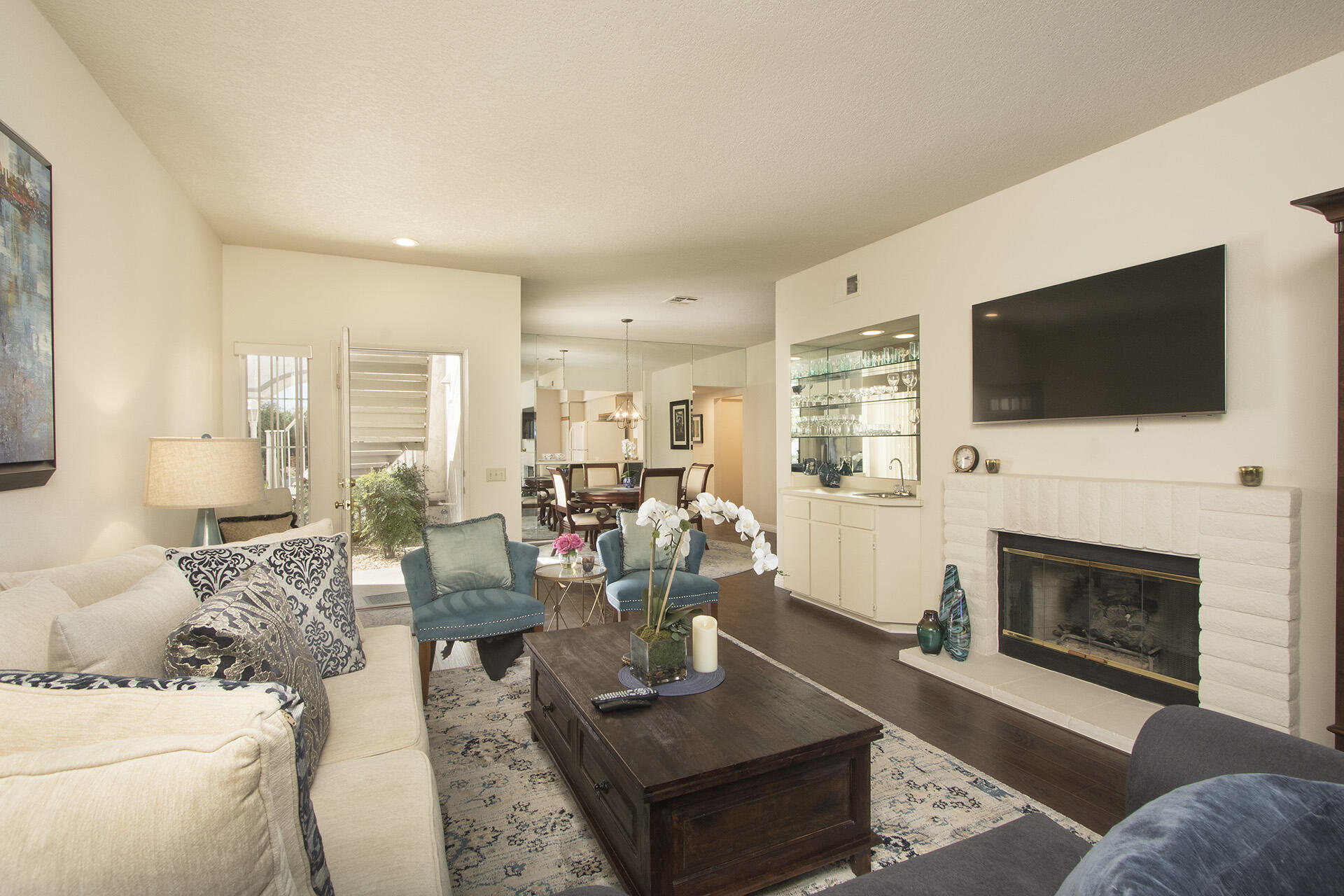 a living room with furniture a fireplace and a flat screen tv