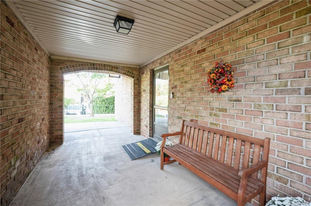 a view of a porch with furniture and floor to ceiling window