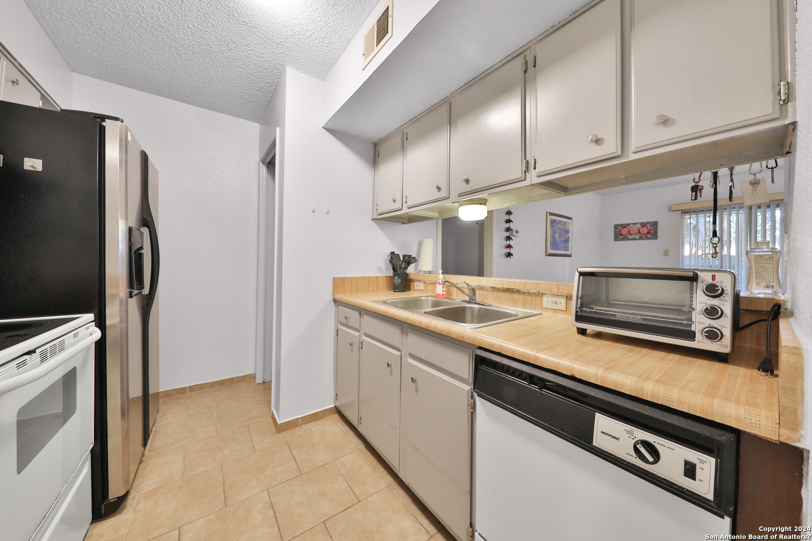 a kitchen with stainless steel appliances a stove a microwave and a refrigerator