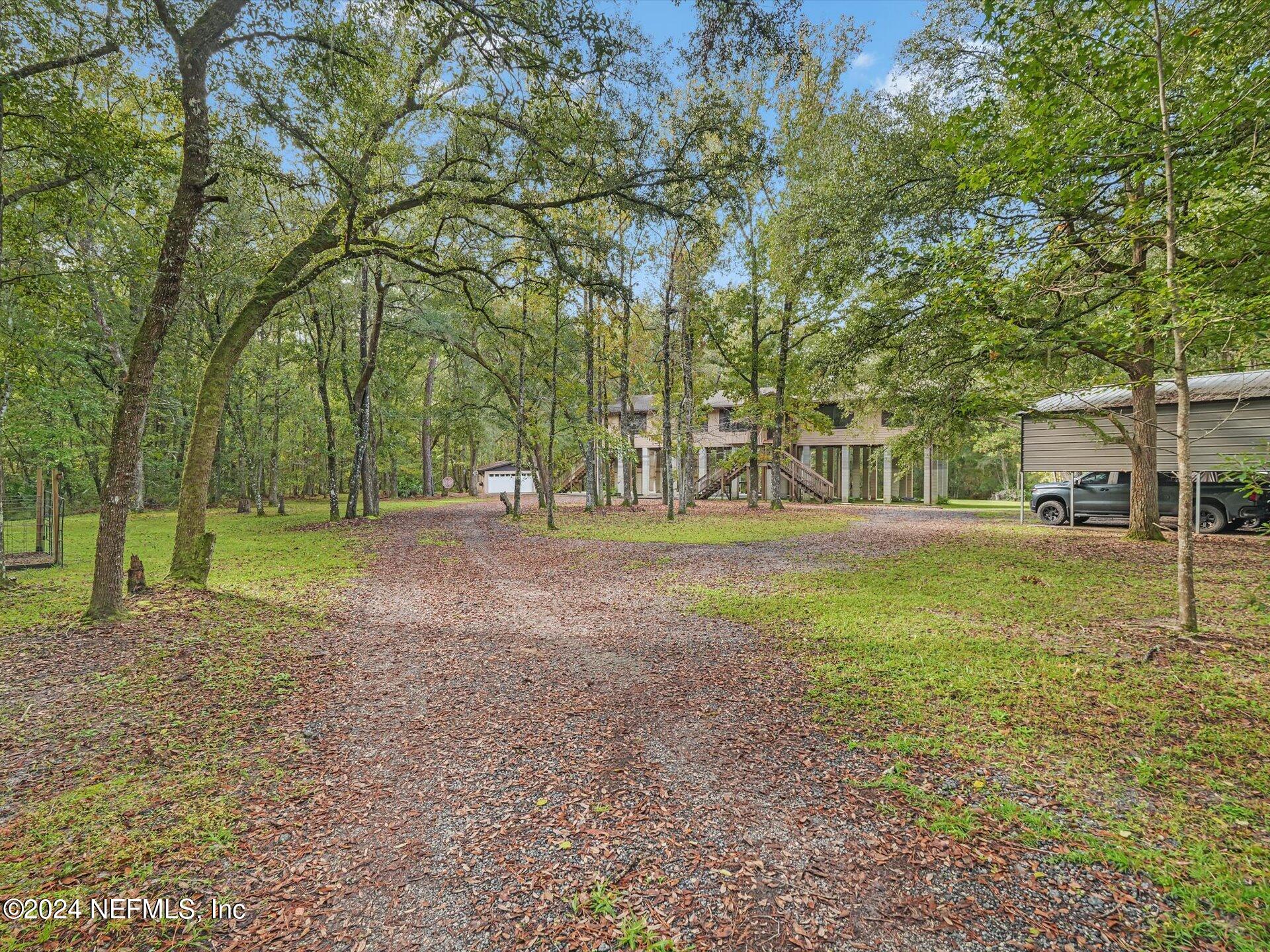 a view of a house with a backyard