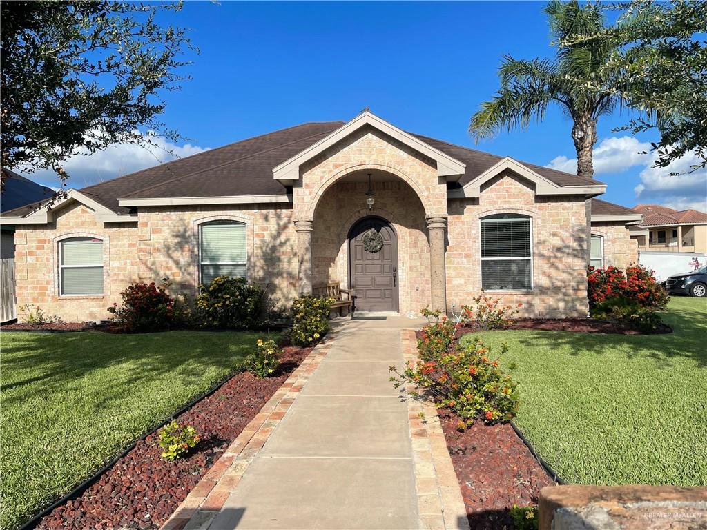 View of front of home featuring a garage and a front lawn