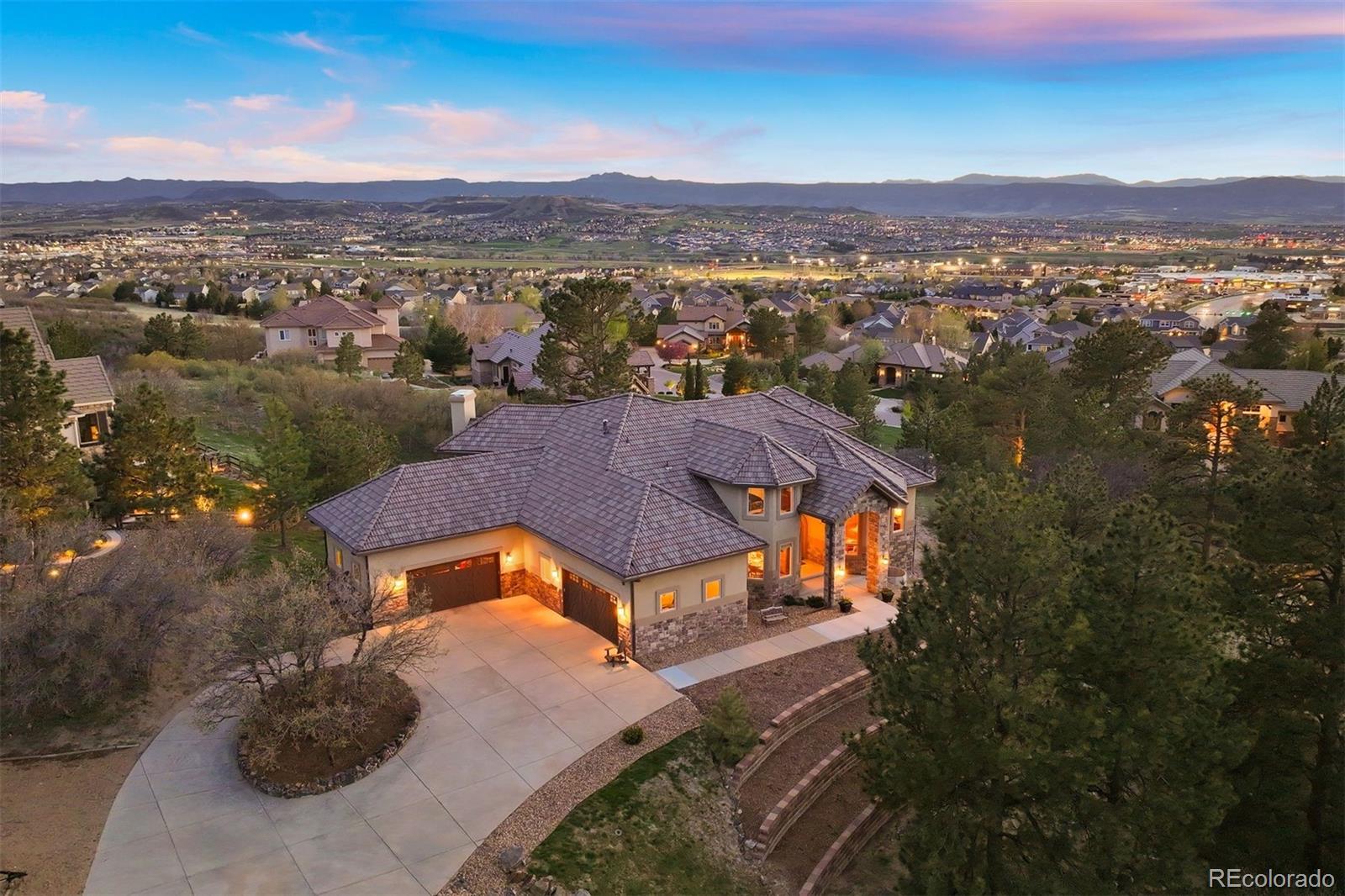 an aerial view of residential houses with outdoor space and ocean view