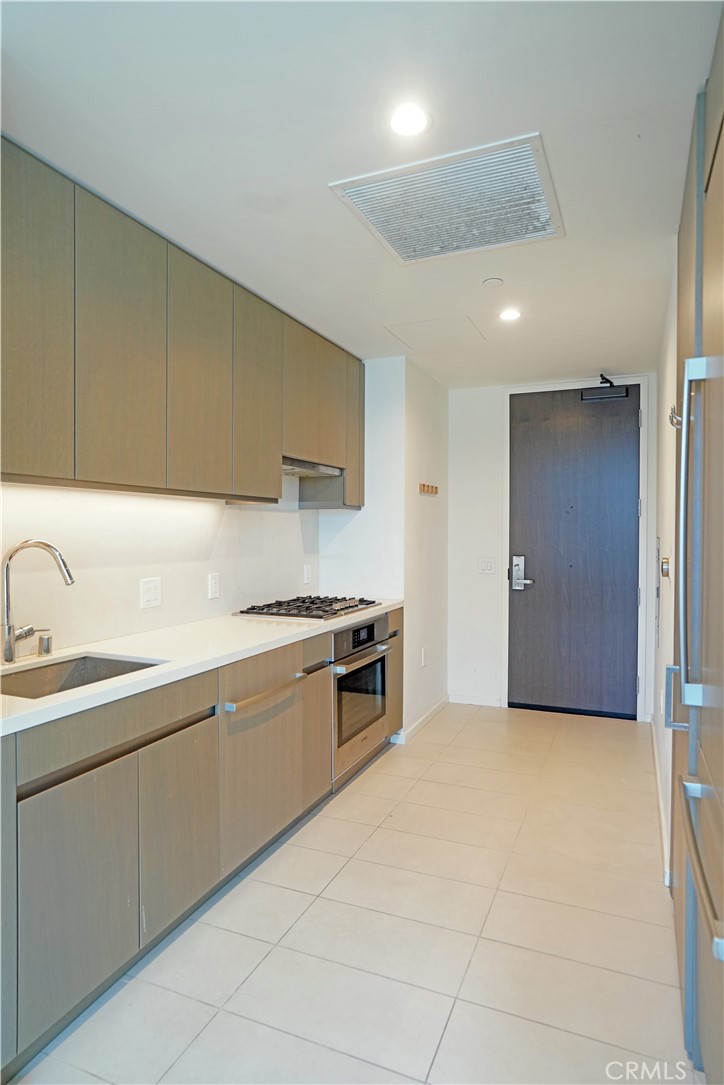 a kitchen with a sink cabinets and appliances