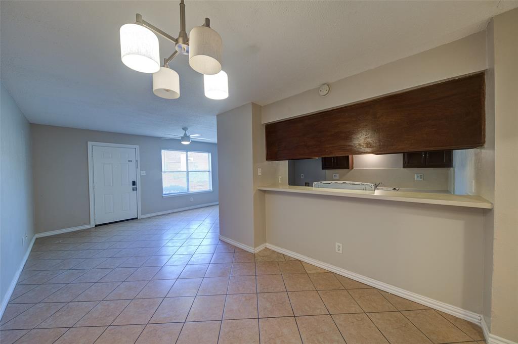 a view of an empty room with a kitchen