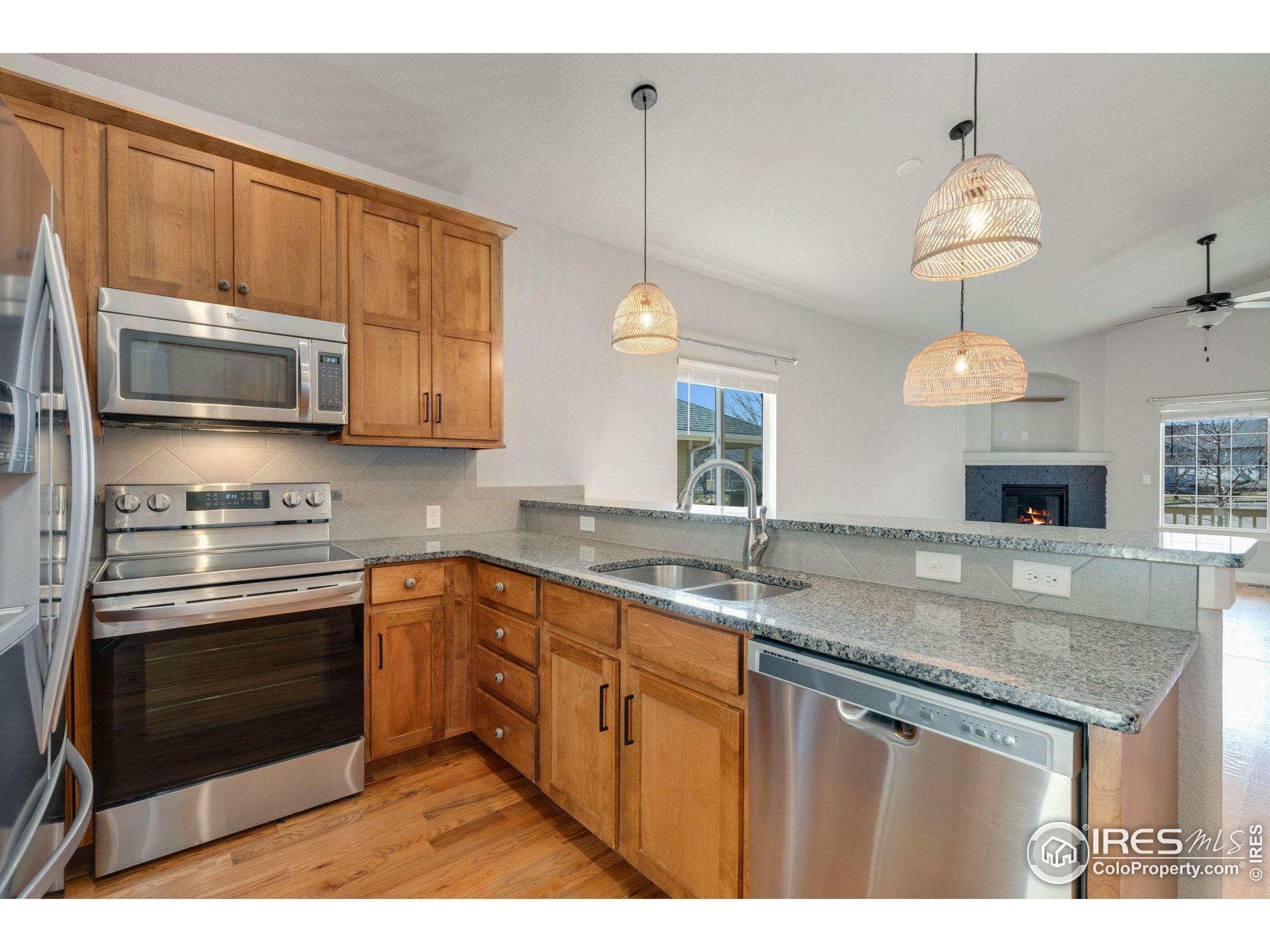 a kitchen with stainless steel appliances granite countertop a sink a stove microwave and cabinets