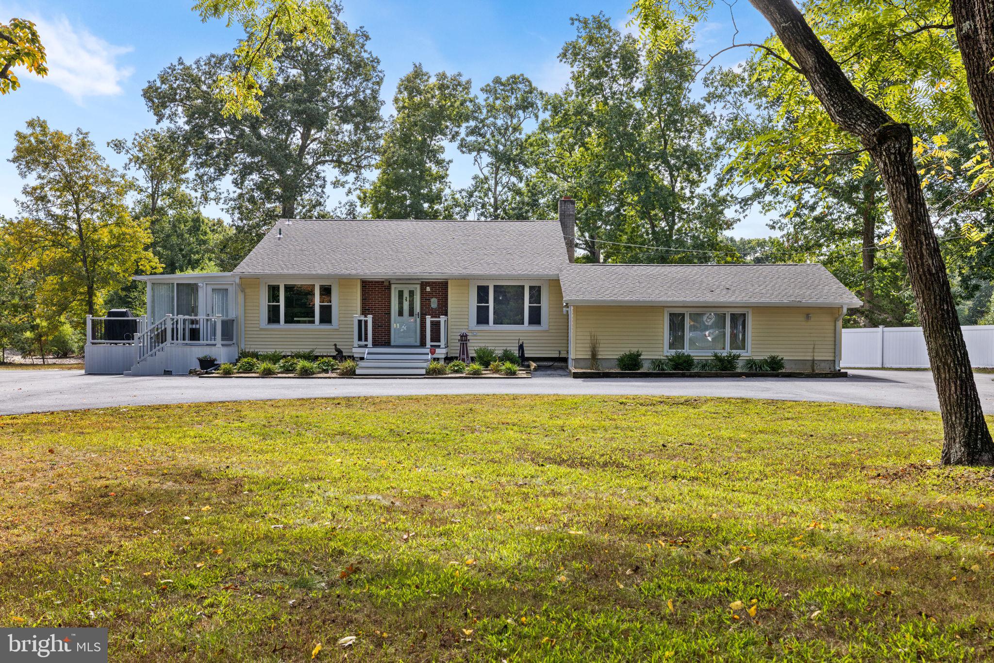 a front view of a house with swimming pool and porch with furniture