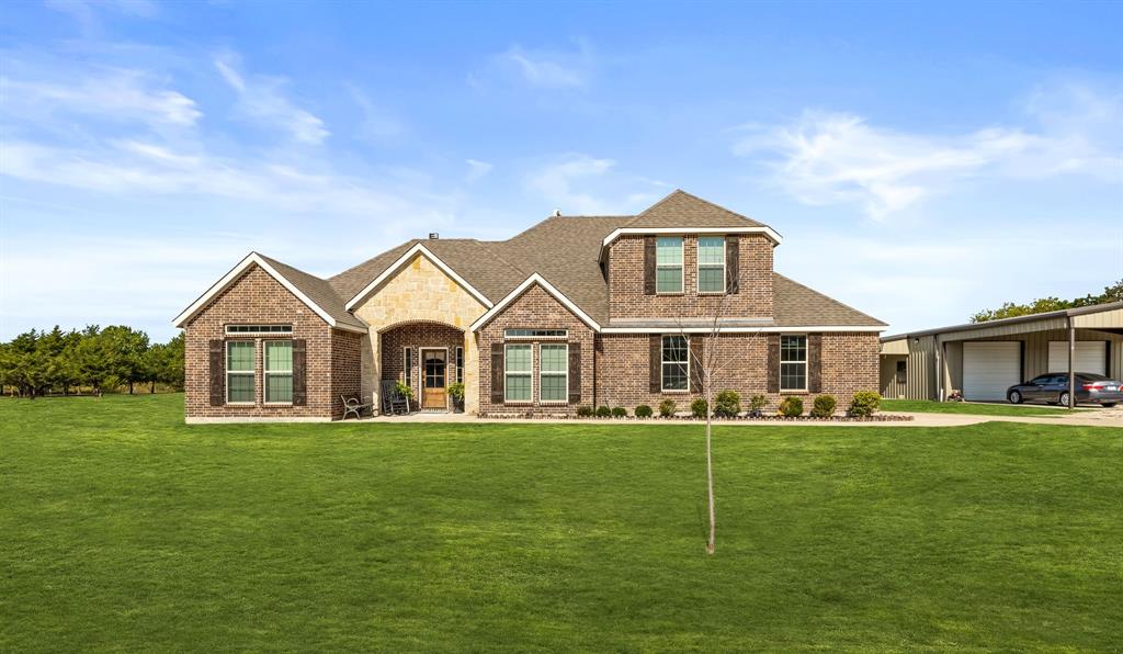 a front view of a house with a yard