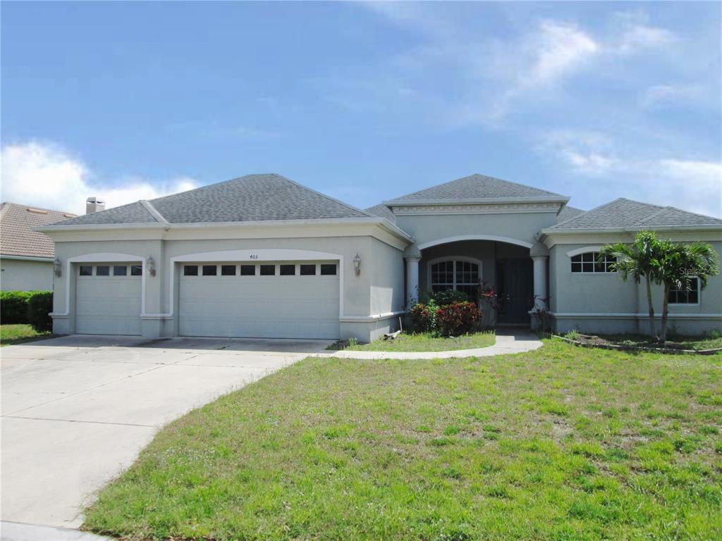 a front view of a house with yard and garage