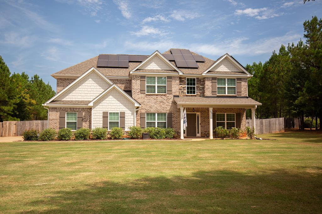 a front view of a house with a yard