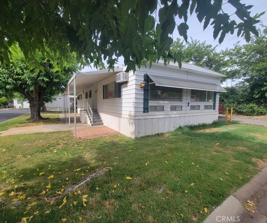 a view of a house with a yard porch and sitting area