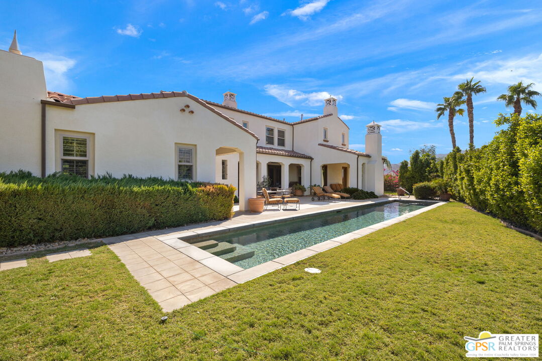 a view of a house with swimming pool and a yard