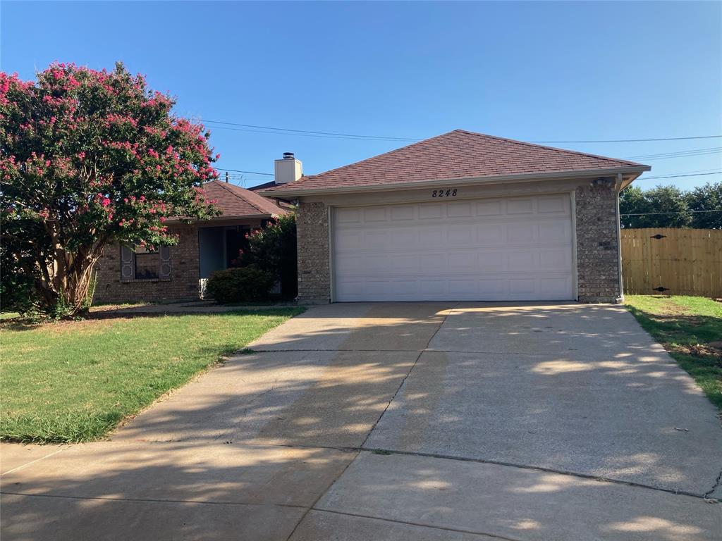 a front view of a house with a yard and a garage