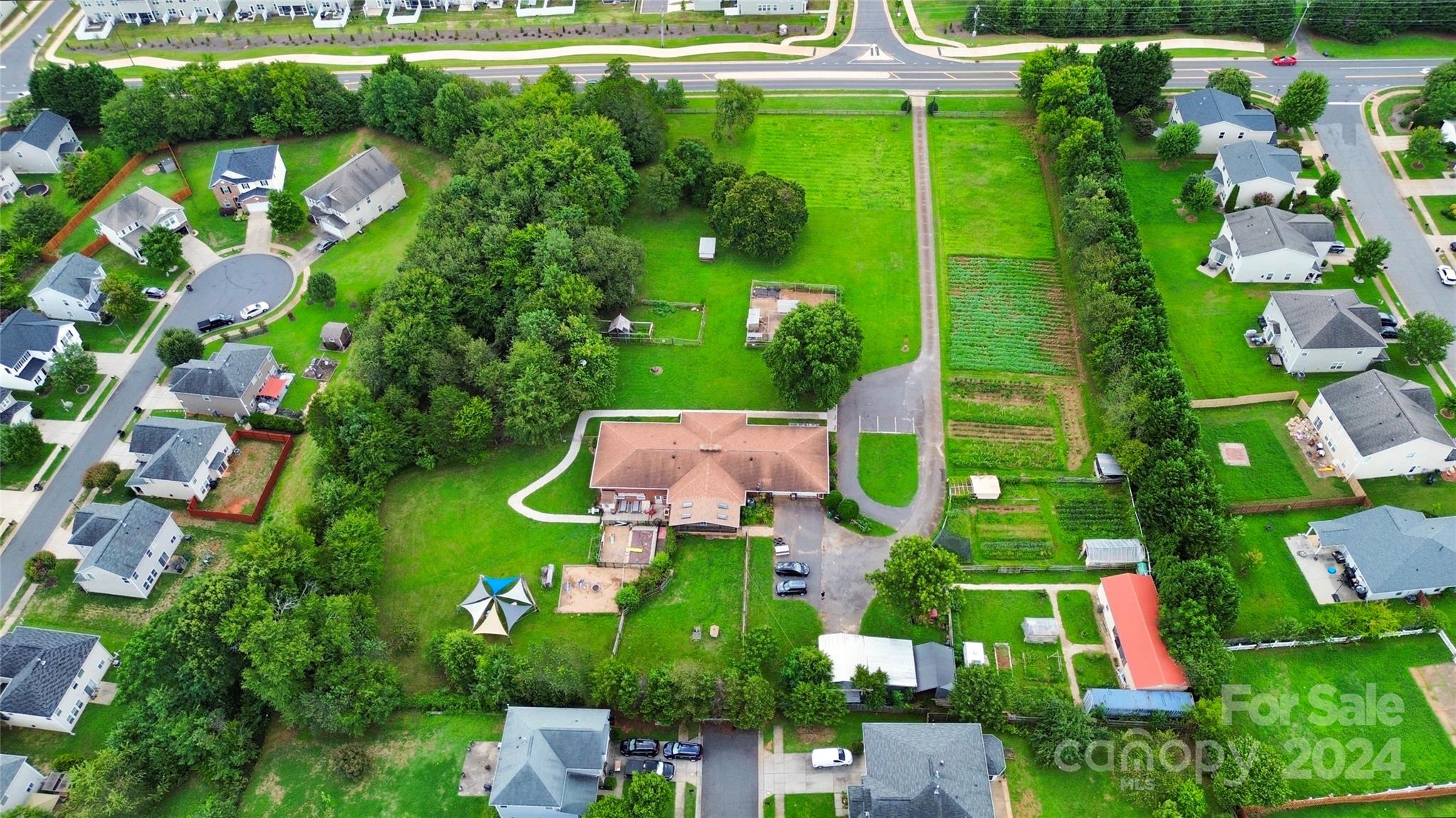 an aerial view of residential houses with outdoor space and street view