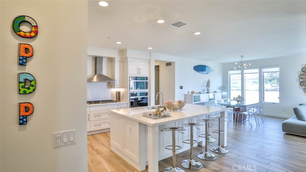 a large kitchen with a table and chairs