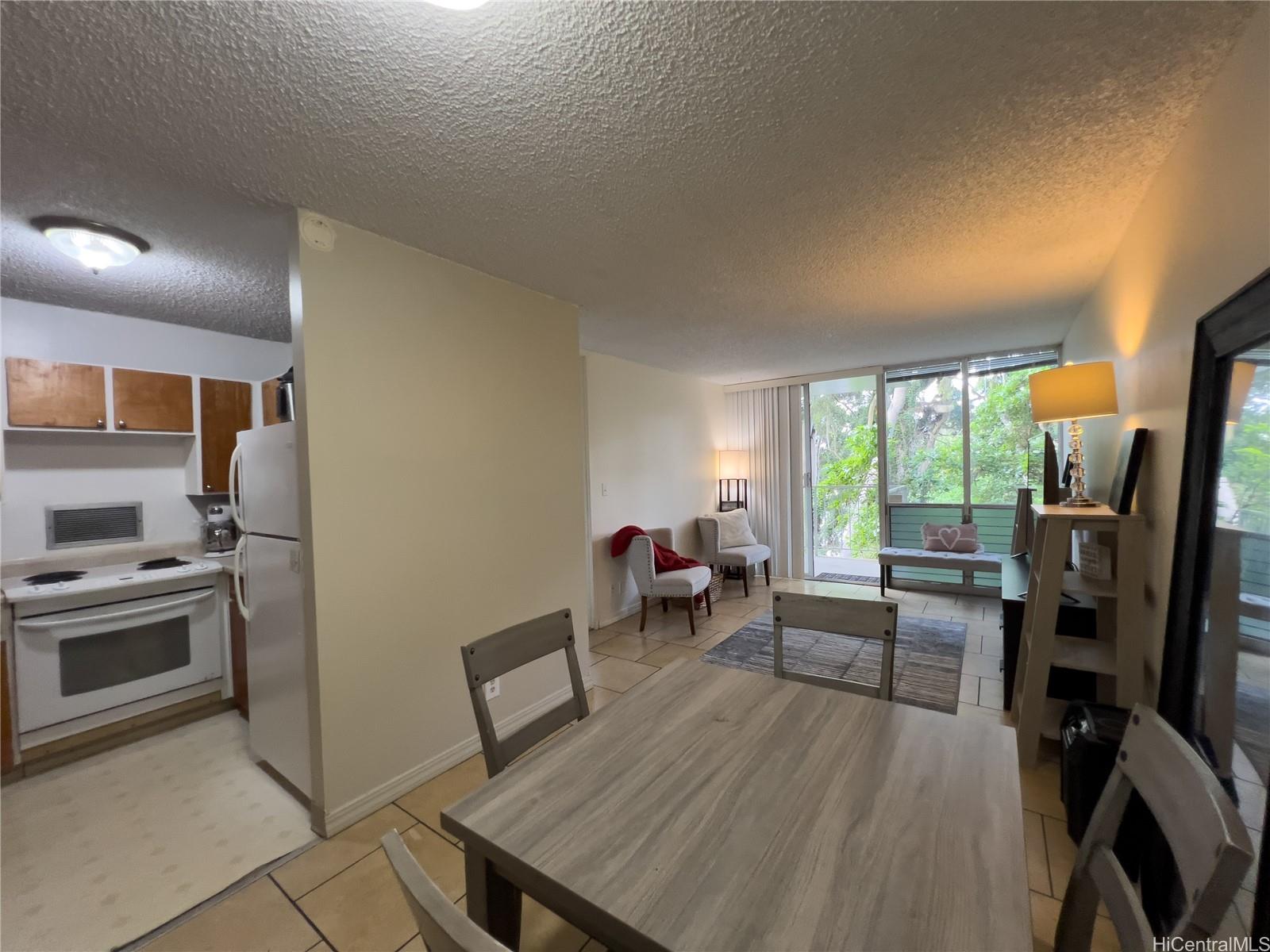 a kitchen with sink refrigerator dining table and chairs