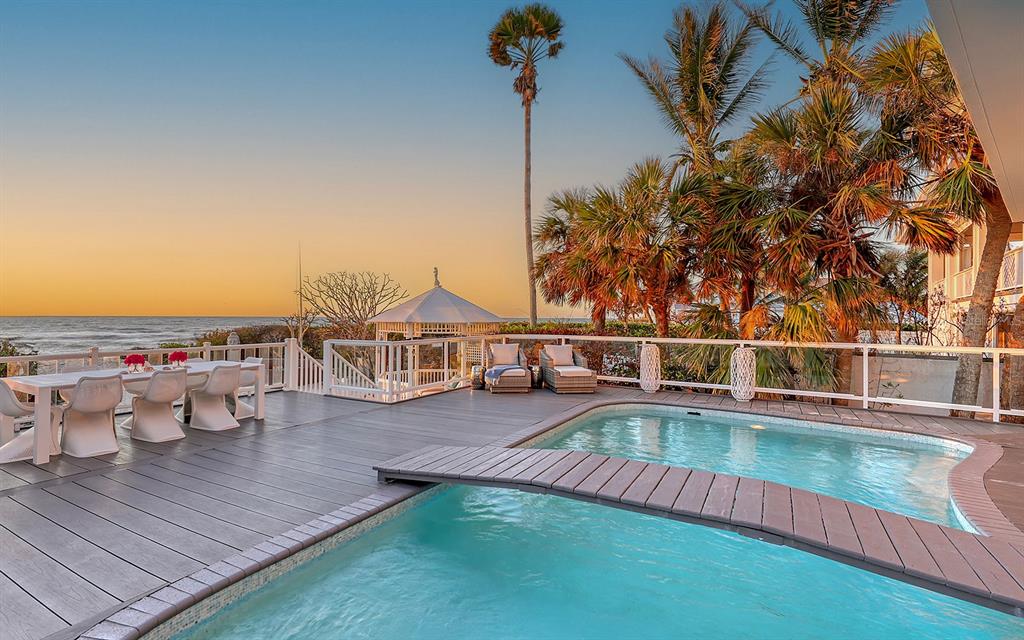 swimming pool view with a seating space