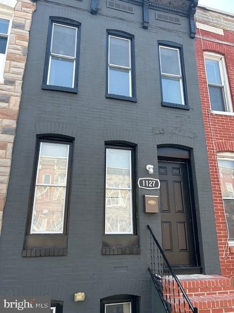 a brick building with four windows