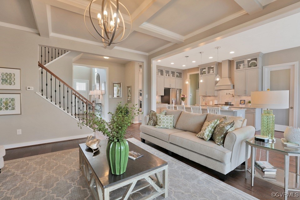 a living room with furniture a chandelier and a dining room