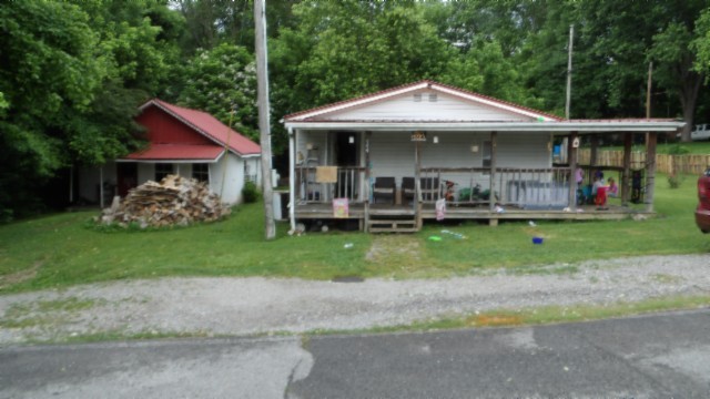 a view of a house with a yard and sitting area