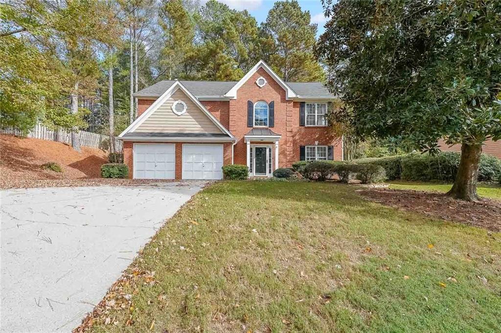 a front view of a house with a yard