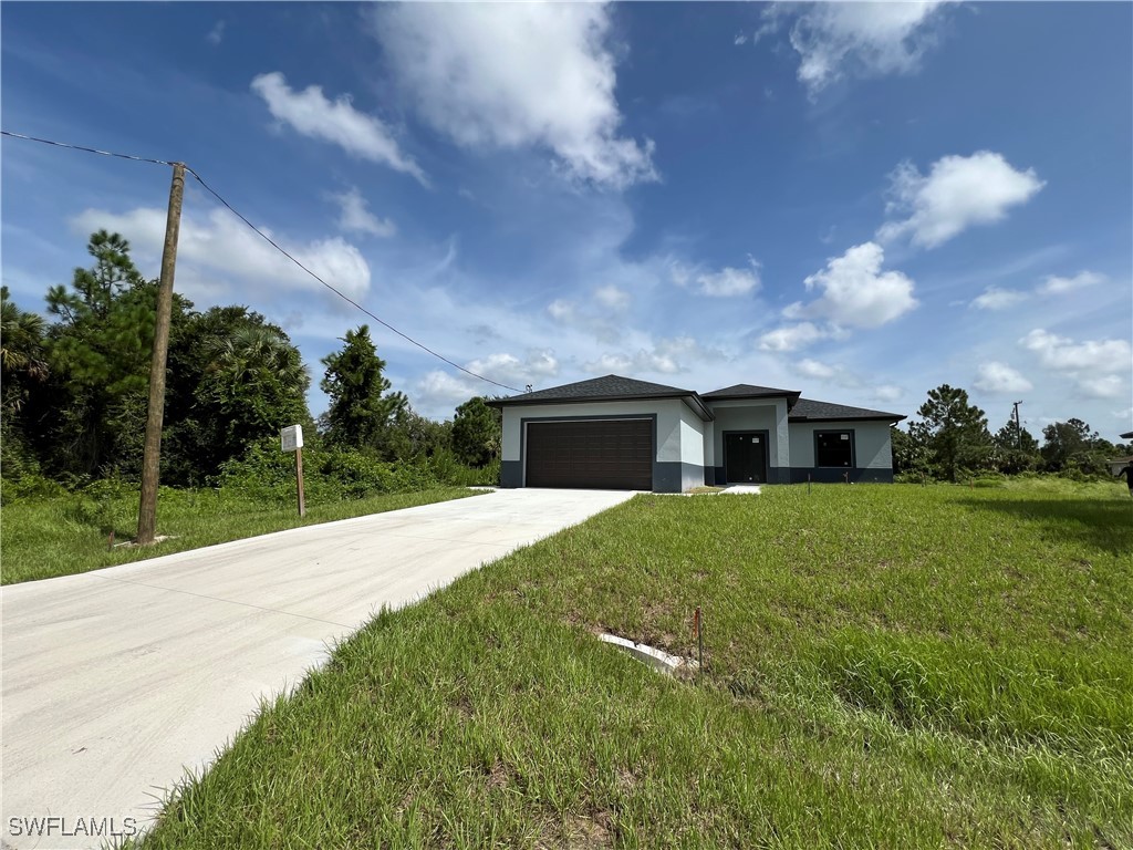 a front view of a house with yard and green space