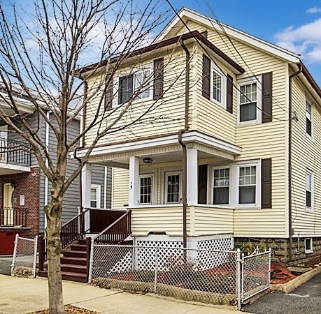 a view of a house with wooden fence