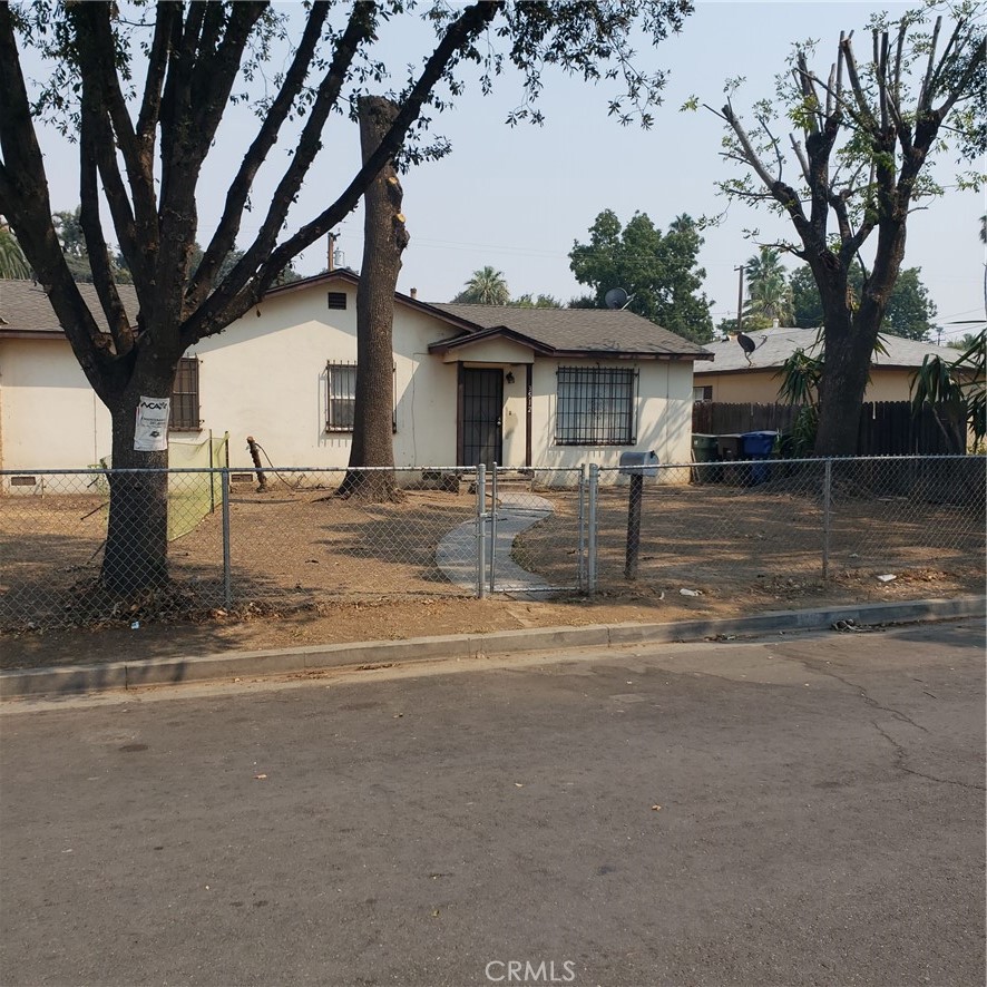 a view of a house with street that has a tree