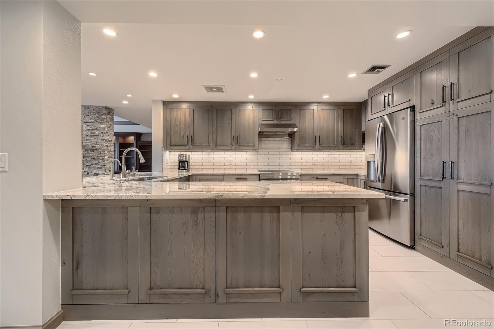 a kitchen with kitchen island a sink stainless steel appliances and cabinets