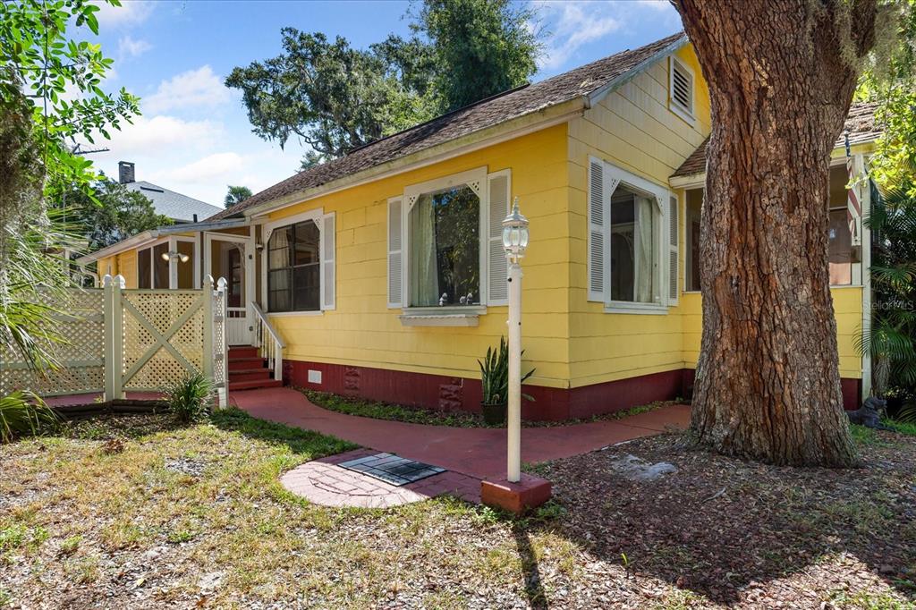 a view of a small house with a yard