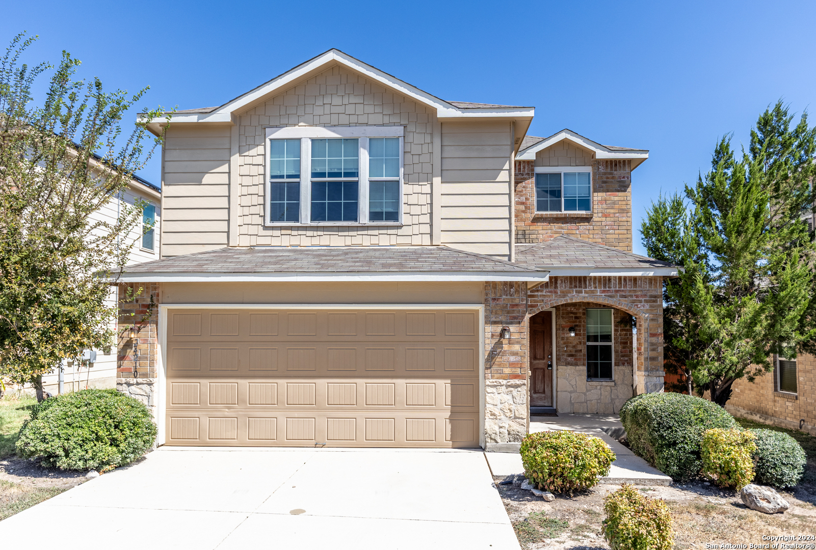 a front view of a house with a garage