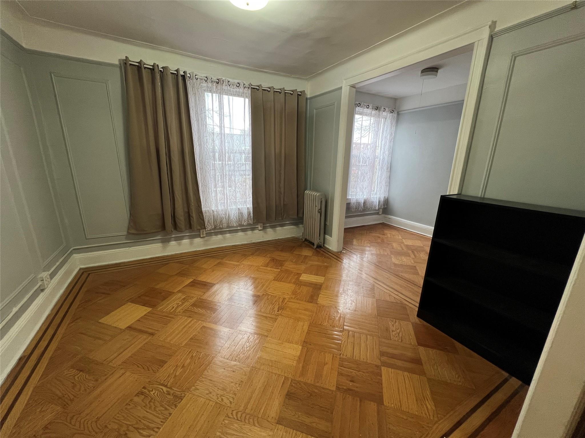 a view of room with window and hardwood