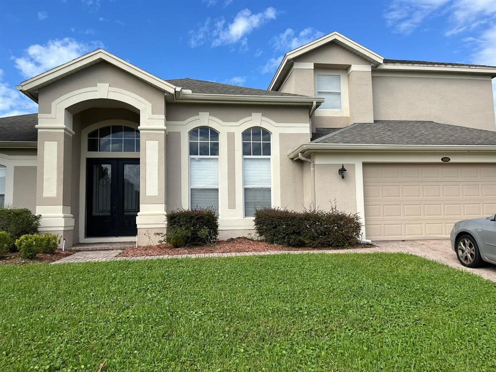 a front view of a house with a yard