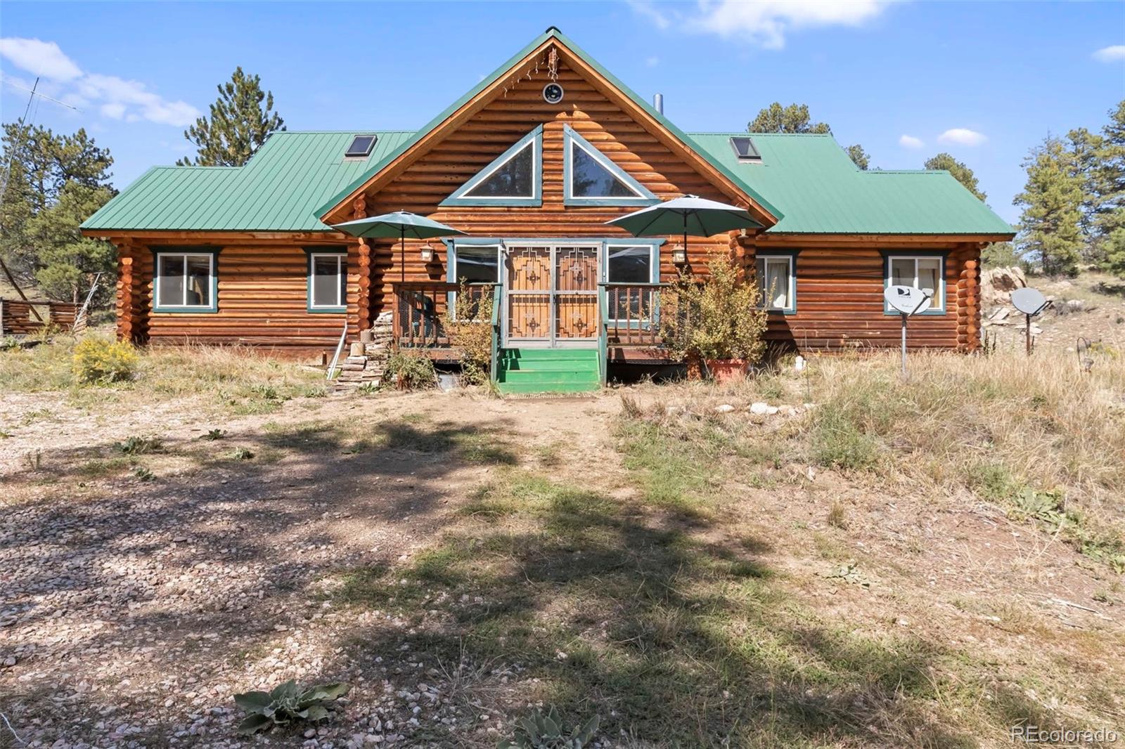 a front view of a house with yard porch and furniture