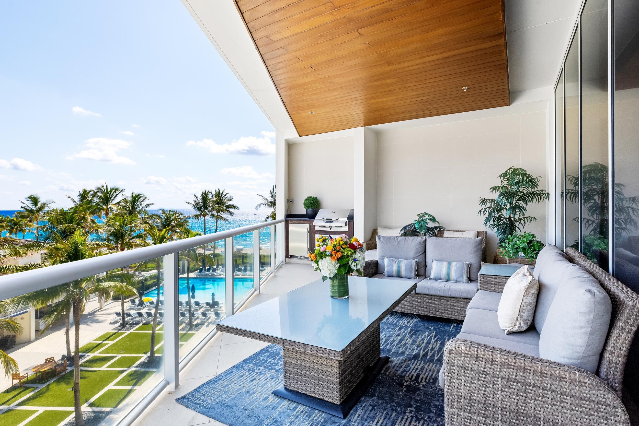 a view of balcony with furniture and wooden floor