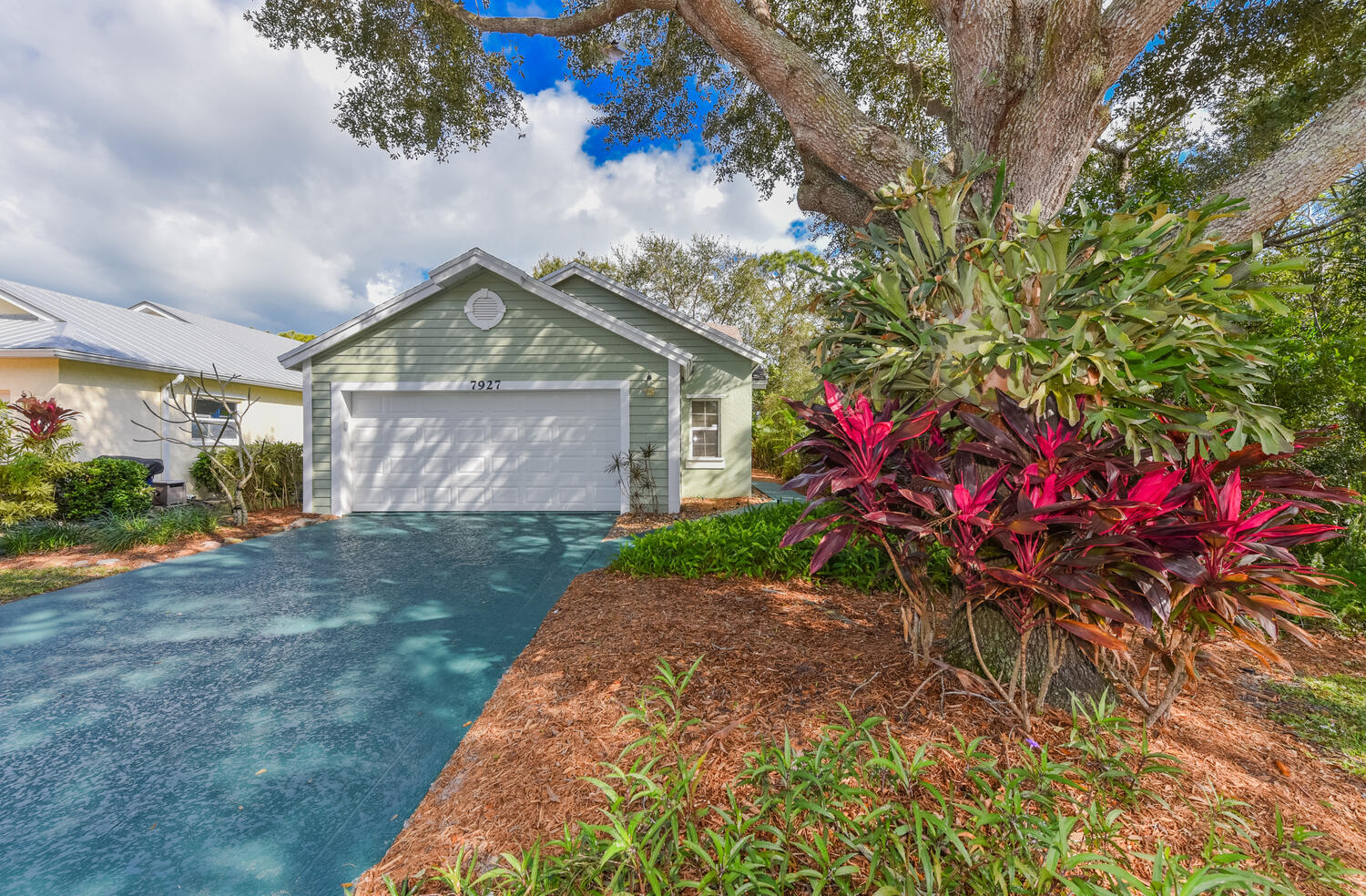 a front view of a house with a yard and a garage