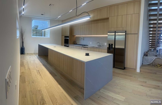 a view of kitchen with cabinets and wooden floor