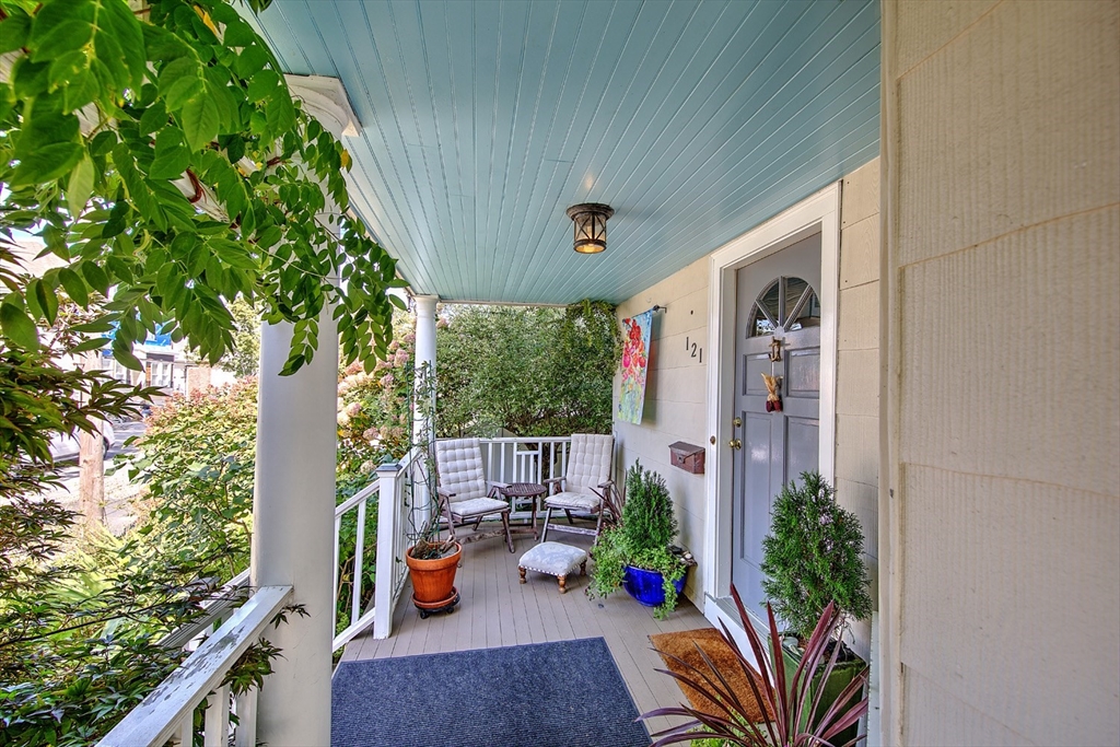 a view of a porch with furniture and garden