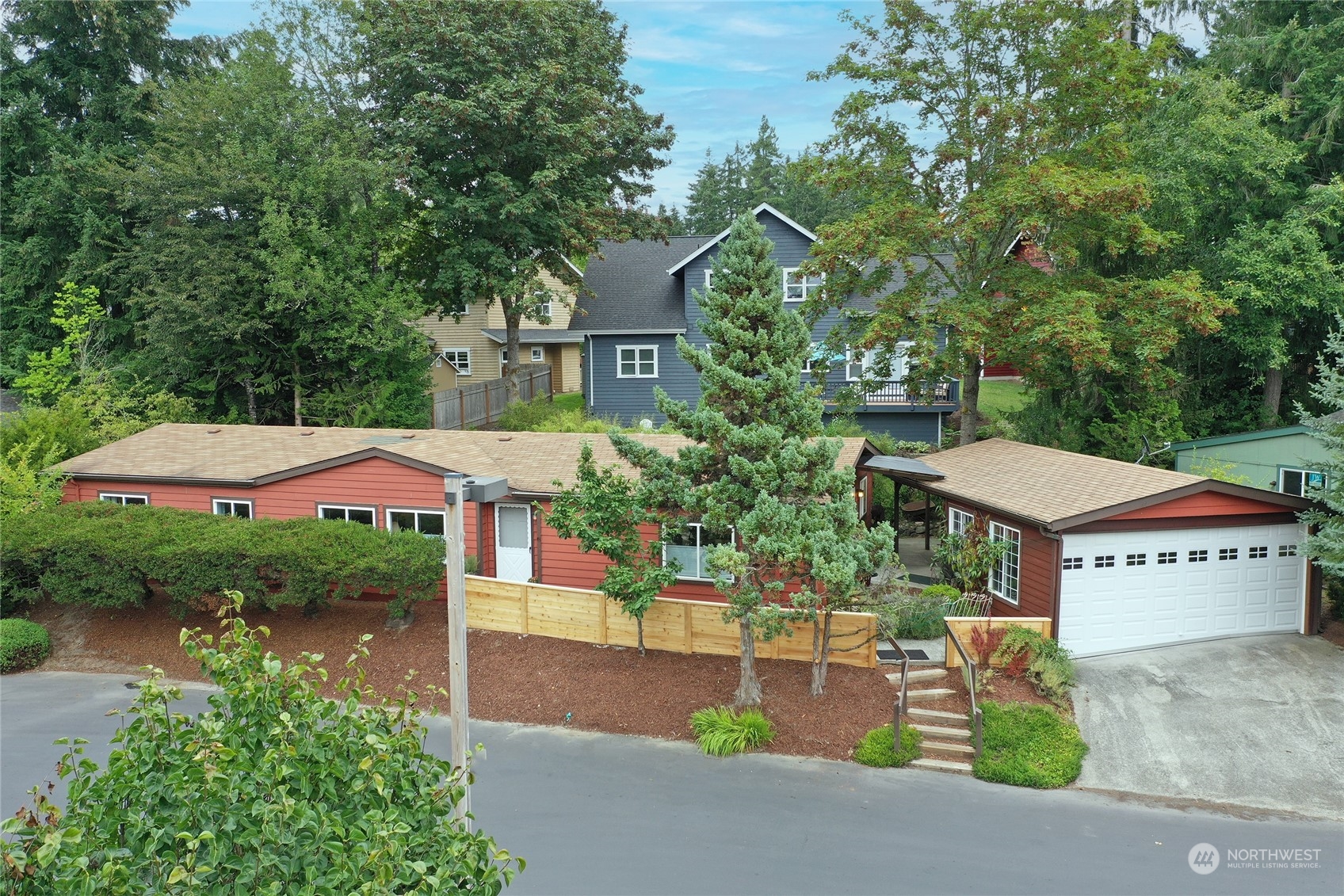 an aerial view of a house with yard and outdoor seating