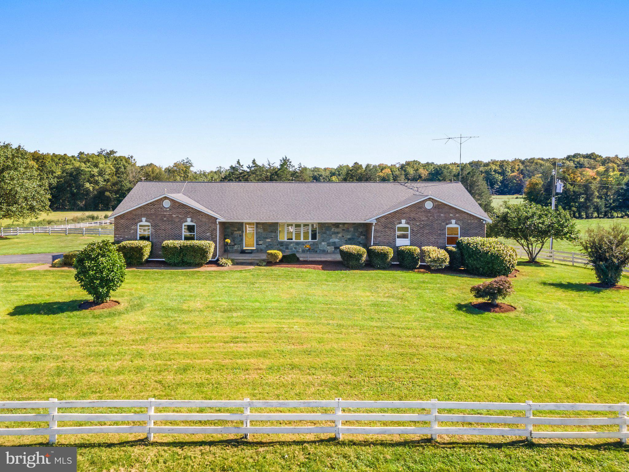 a front view of house with yard and lake view